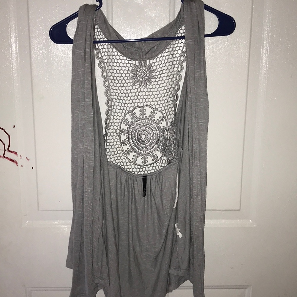 A Tank top with designs on the back and it’s gray